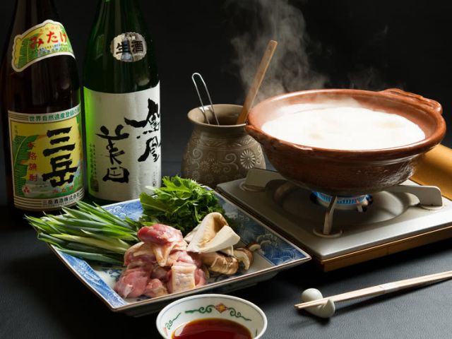 Japanese ryokan kaiseki dinner sets serve in family private room including  appetizer such as cherry blossom tofu, pork shabu hot pot and basket,  sashimi, fried and warm dishes and plum liquor Stock